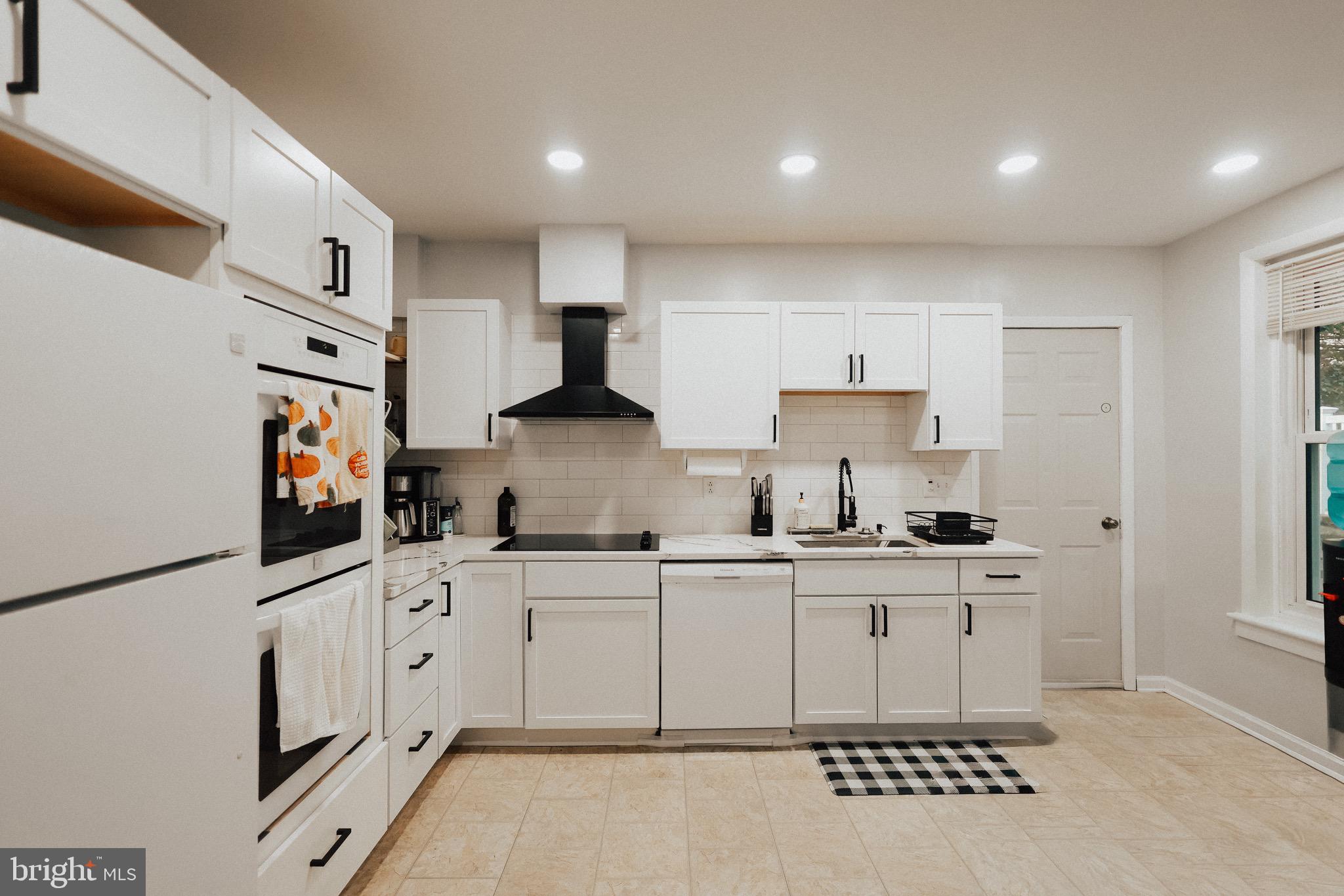 11 Seminary Avenue Reading, PA 19605 - Photo 3 of 15 a kitchen with stainless steel appliances a sink a stove a refrigerator cabinets and a window