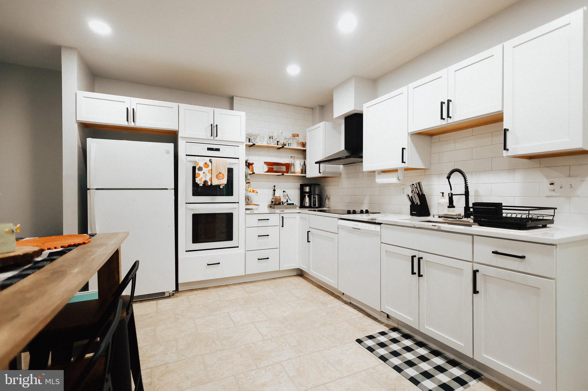 11 Seminary Avenue Reading, PA 19605 - Photo 4 of 15 a kitchen with stainless steel appliances a refrigerator sink and white cabinets