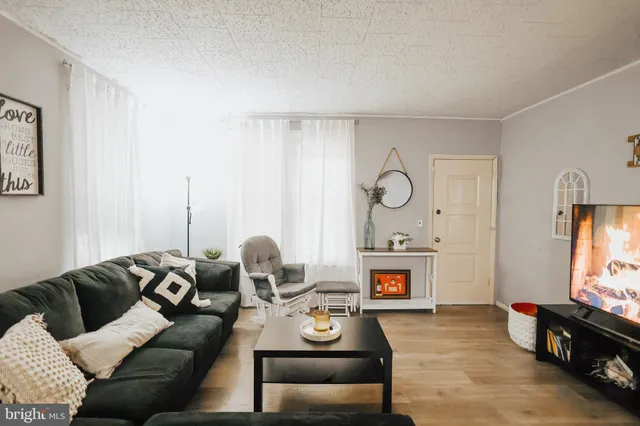 a living room with furniture fireplace and flat screen tv