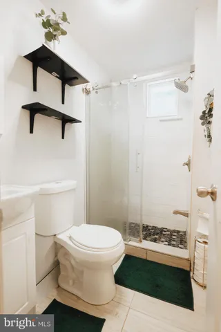 a bathroom with a toilet and a shower