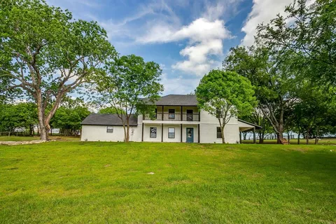 a house view with swimming pool in front of it