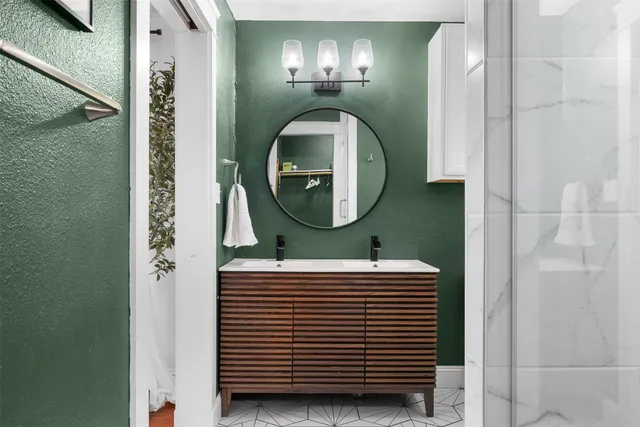 a bathroom with a mirror a sink and a mirror