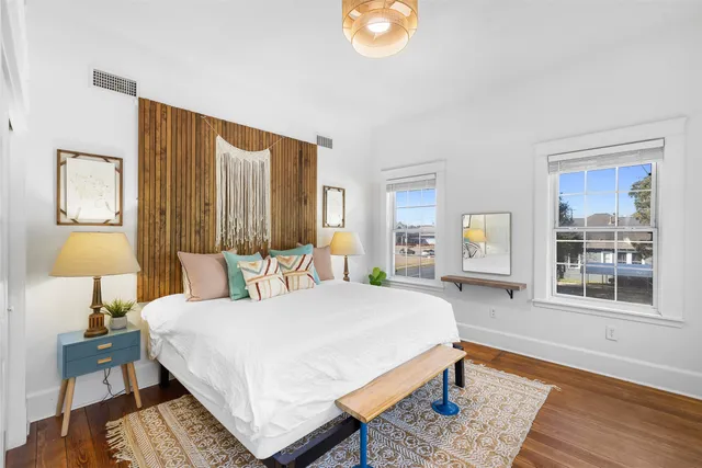 a bedroom with a bed lamps and window