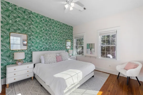 a bedroom with a bed and a chandelier