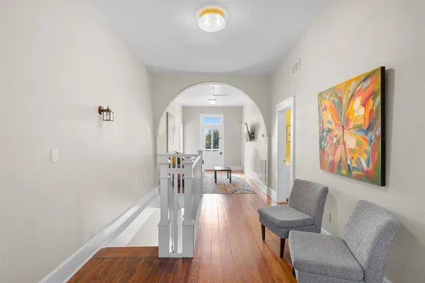 a view of a livingroom with furniture and hardwood floor