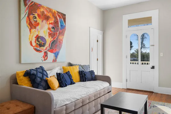 a bedroom with a bed and wooden floor