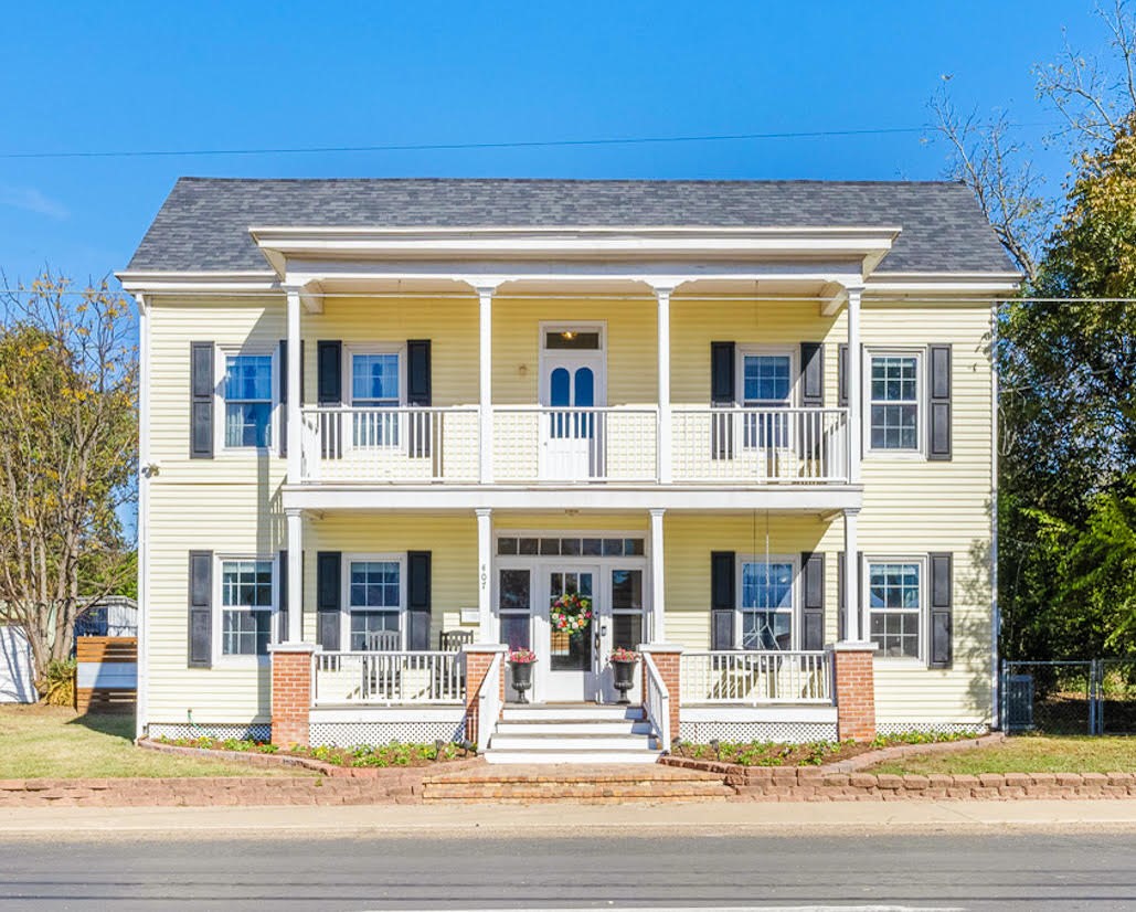 407 East Alamo Street Brenham, TX 77833 - Photo 2 of 27 a view of a building with a outdoor space