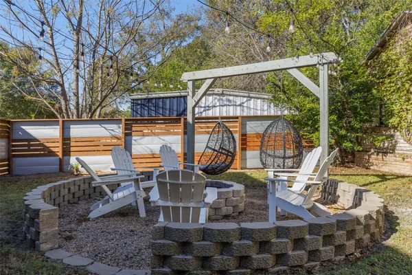 a view of a patio with iron fence