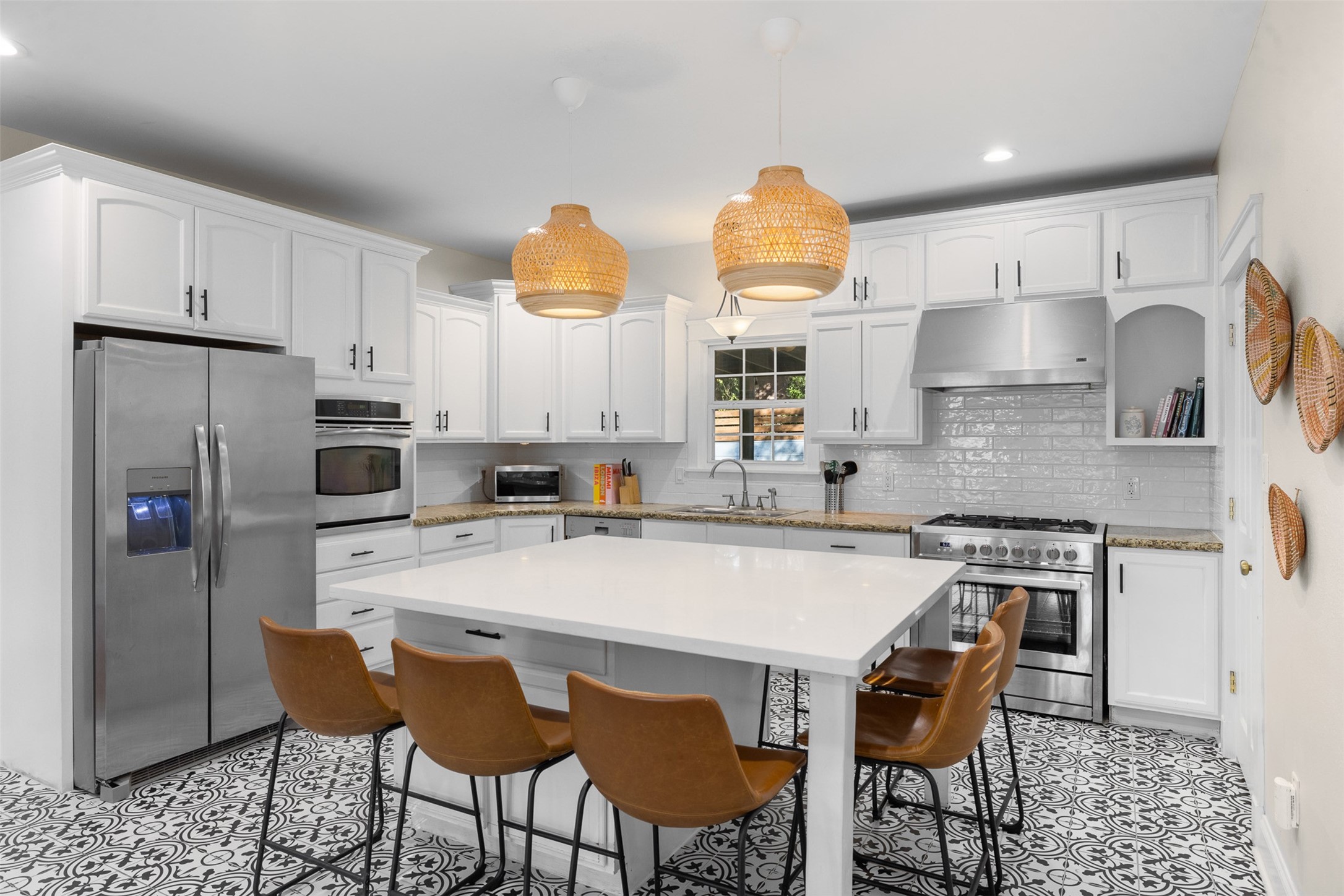 407 East Alamo Street Brenham, TX 77833 - Photo 6 of 27 a kitchen with stainless steel appliances a dining table chairs refrigerator and sink