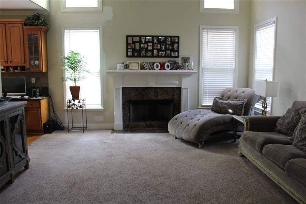 3411 Jim Moore Road Dacula, GA 30019 - Photo 13 of 54 a living room with furniture a flat screen tv and a fireplace