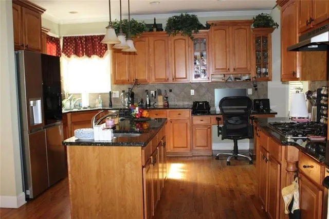 a kitchen with stainless steel appliances granite countertop a stove and a microwave