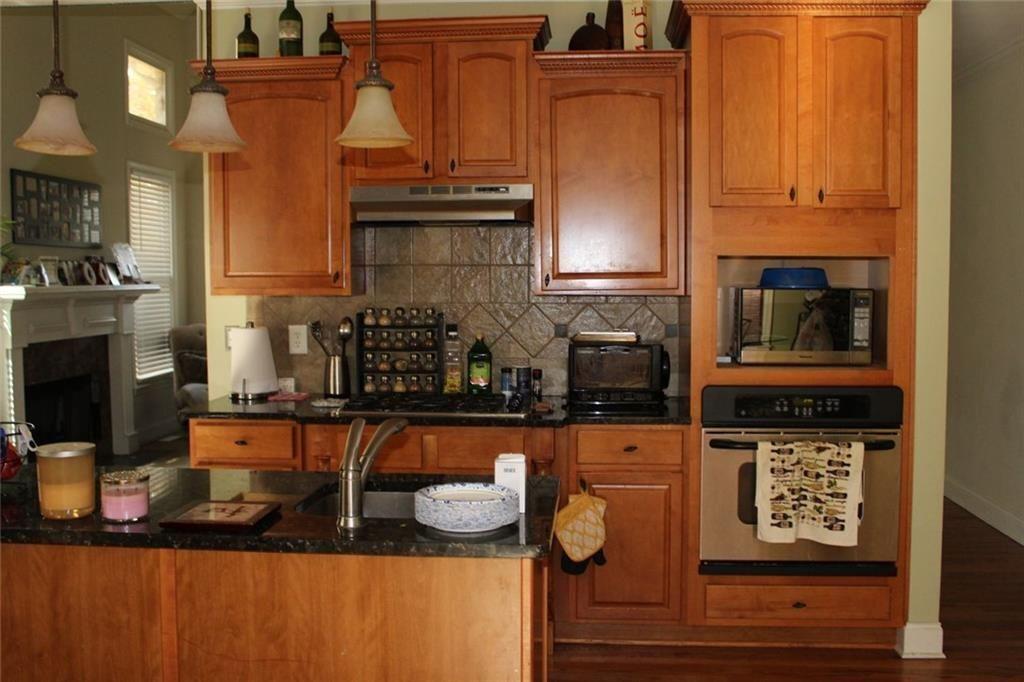 3411 Jim Moore Road Dacula, GA 30019 - Photo 16 of 54 a kitchen with stainless steel appliances granite countertop a stove and a microwave