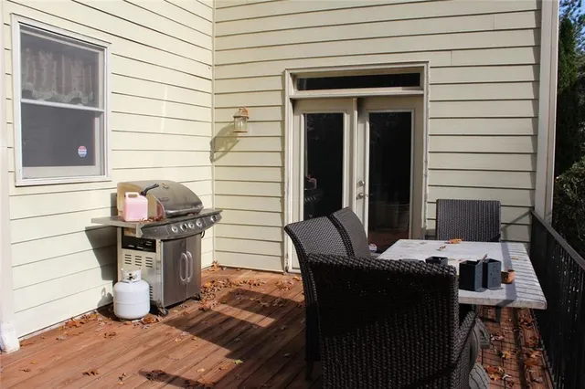 a view of a wooden deck next to a yard