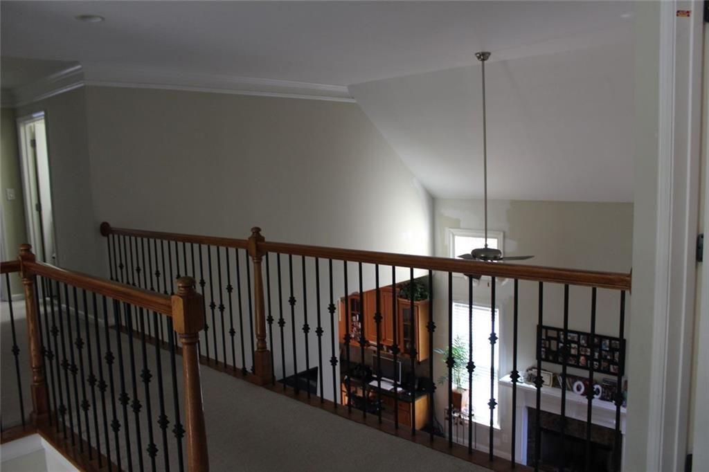 3411 Jim Moore Road Dacula, GA 30019 - Photo 22 of 54 a view of staircase with railing fan and white floor