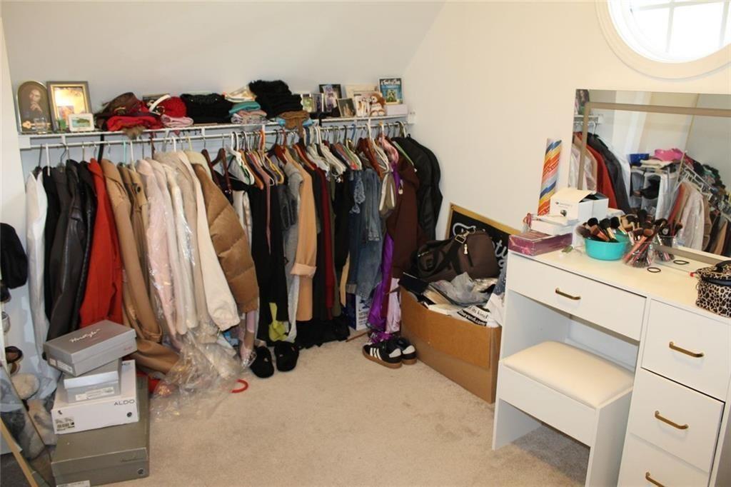 3411 Jim Moore Road Dacula, GA 30019 - Photo 34 of 54 a view of walk in closet with clothes