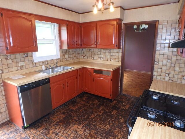 557 Old Meadow Road Matteson, IL 60443 - Photo 4 of 16 a kitchen with a sink stove and cabinets