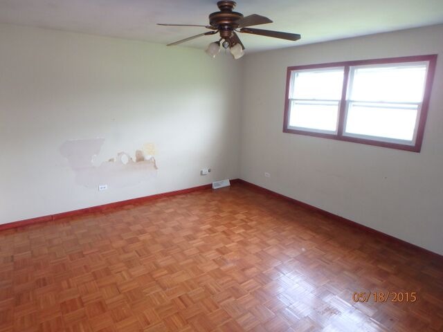557 Old Meadow Road Matteson, IL 60443 - Photo 10 of 16 an empty room with chandelier fan and windows