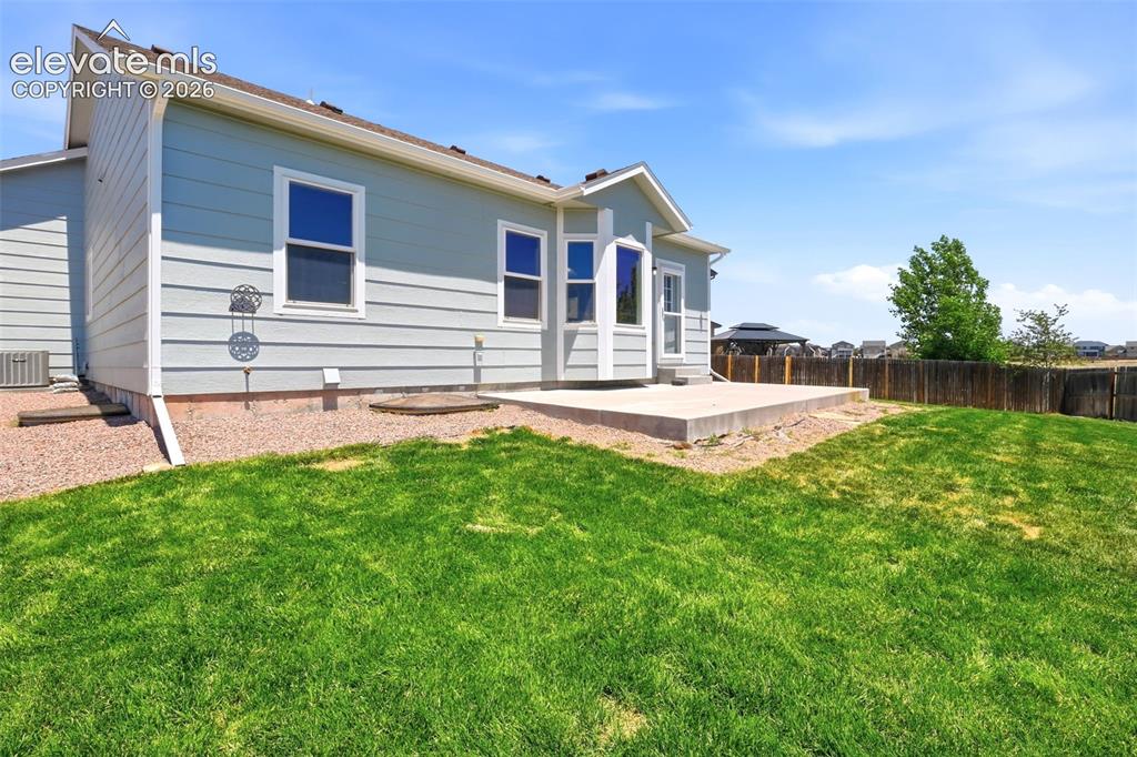 7806 Dutch Loop Colorado Springs, CO 80925 - Photo 30 of 41 a view of a house with a yard and sitting area