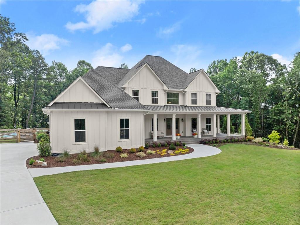 6998 Britt Gailey Road Clermont, GA 30527 - Photo 74 of 92 a front view of a house with garden and trees