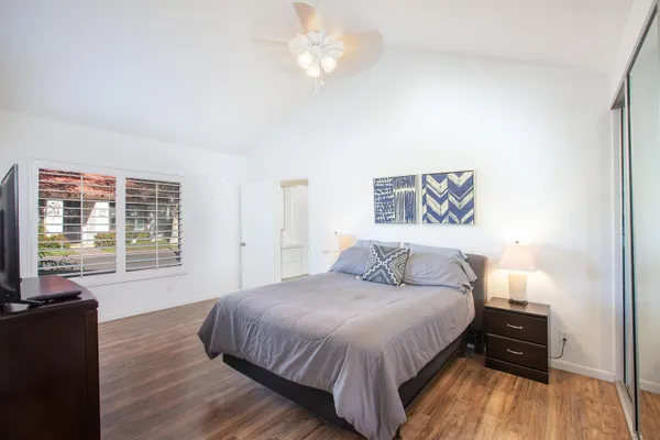 a spacious bedroom with a bed and a large window