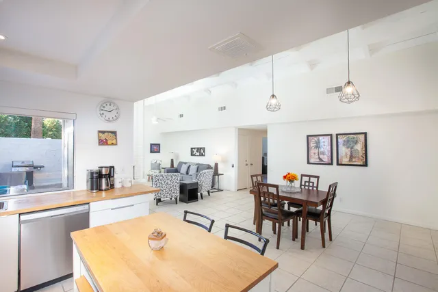 a living room with furniture and a dining table