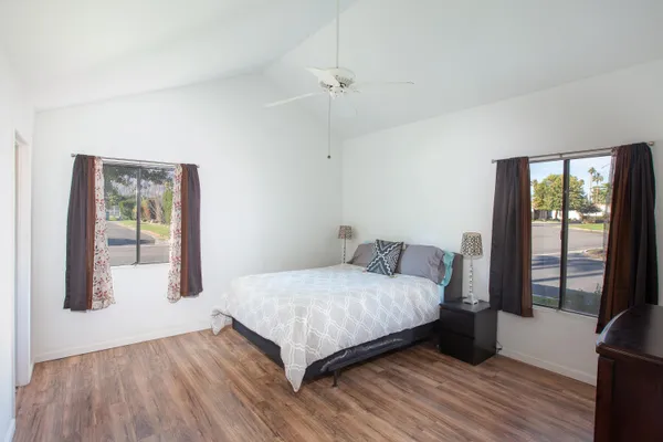 a bedroom with a bed and large window