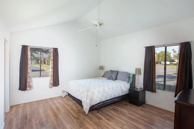 a bedroom with a bed and large window
