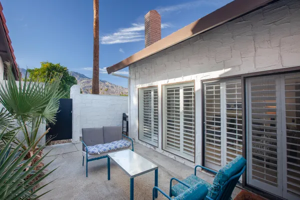 a balcony with furniture and a potted plant