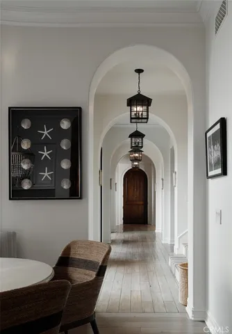 a view of a hallway with entryway wooden floor and livingroom view