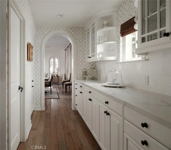 a living room with furniture kitchen view and a flat screen tv