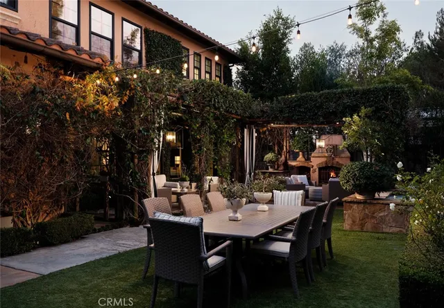 a view of a patio with couches table and chairs and potted plants