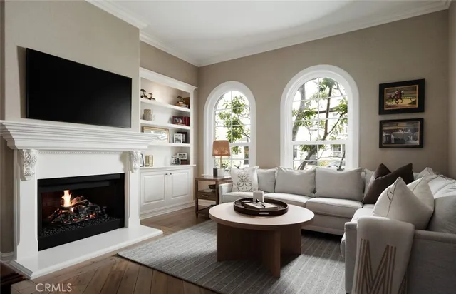 a living room with furniture a flat screen tv and a fireplace