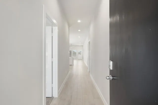 a view of a hallway with wooden floor