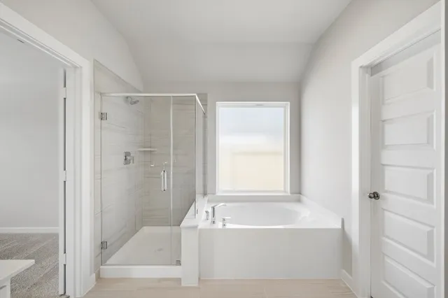 a bathroom with a bathtub and a shower