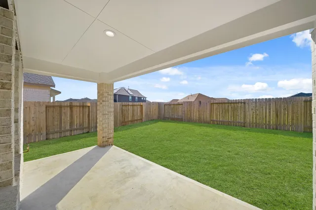 a view of a backyard with wooden fence