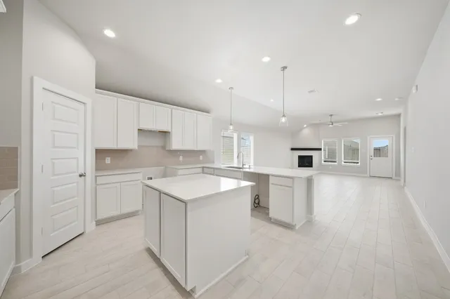 a kitchen with a sink stove and cabinets