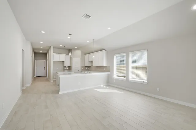 a view of an empty room and a window