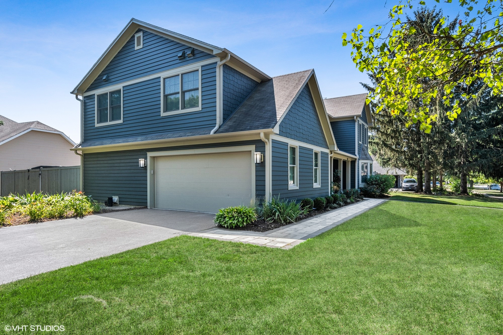 86 South River Road Naperville, IL 60540 - Photo 3 of 34 a front view of a house with a garden and plants