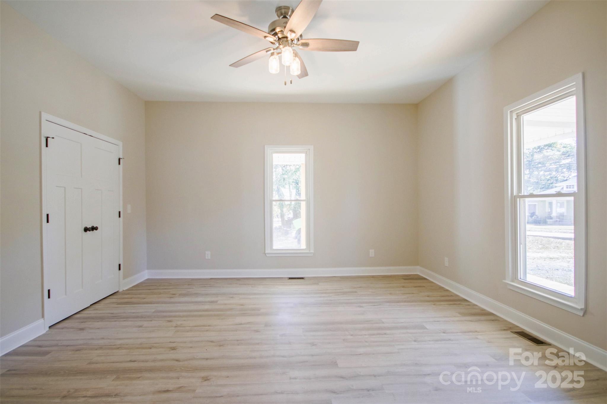 119 Marion Street Clover, SC 29710 - Photo 18 of 45 a view of empty room with wooden floor and fan