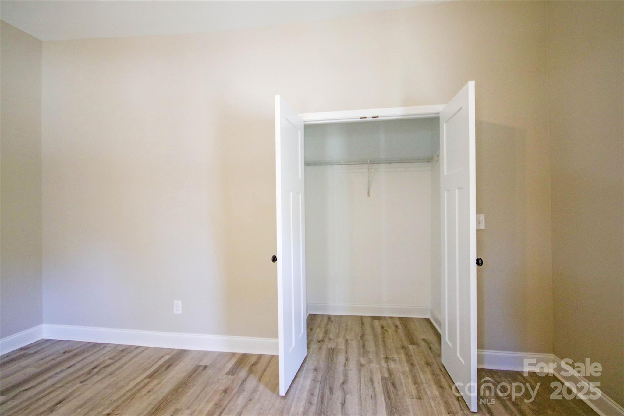 119 Marion Street Clover, SC 29710 - Photo 22 of 45 an empty room with wooden floor and closet