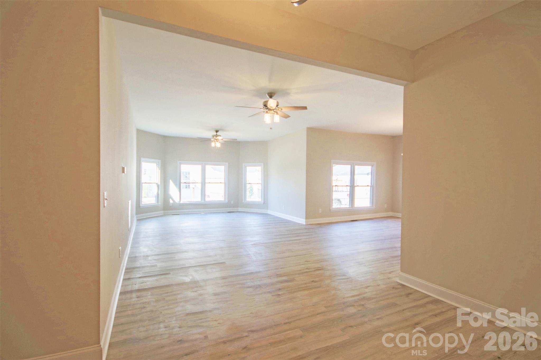 119 Marion Street Clover, SC 29710 - Photo 26 of 46 a view of an empty room with a window and wooden floor