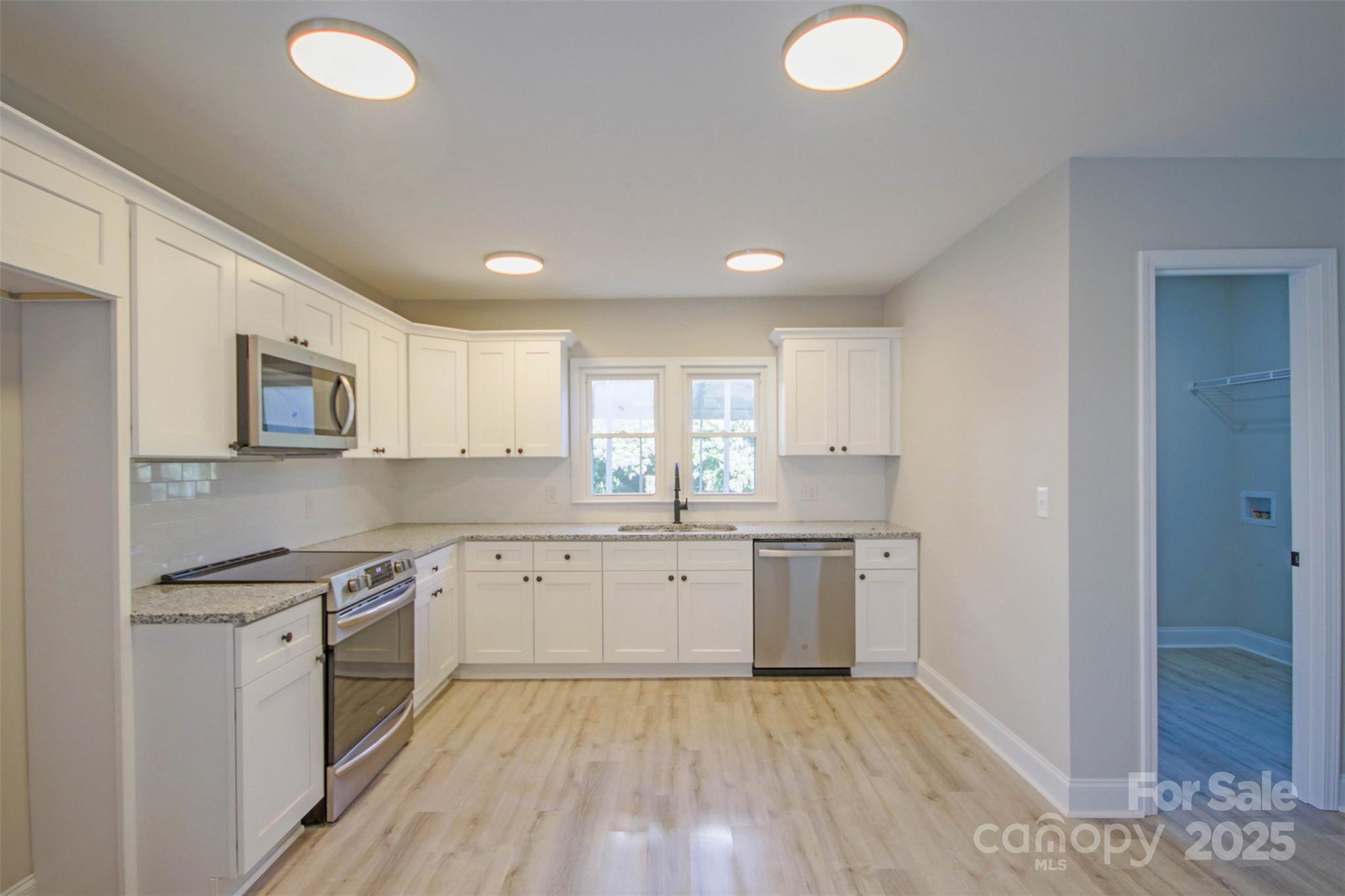 119 Marion Street Clover, SC 29710 - Photo 29 of 45 a kitchen with granite countertop a sink cabinets stainless steel appliances and a window