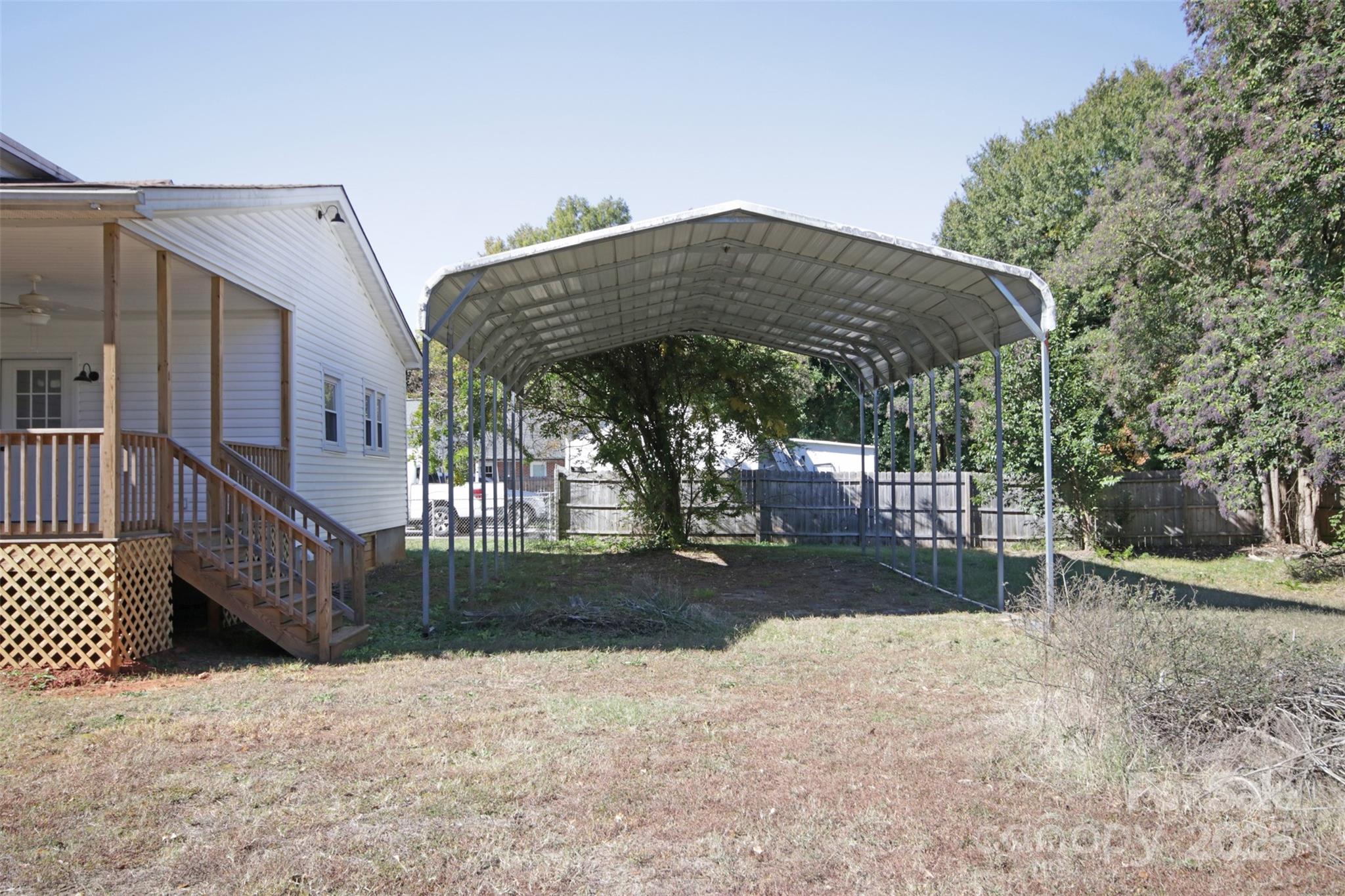 119 Marion Street Clover, SC 29710 - Photo 8 of 45 a view of a white house in front of a yard with wooden fence