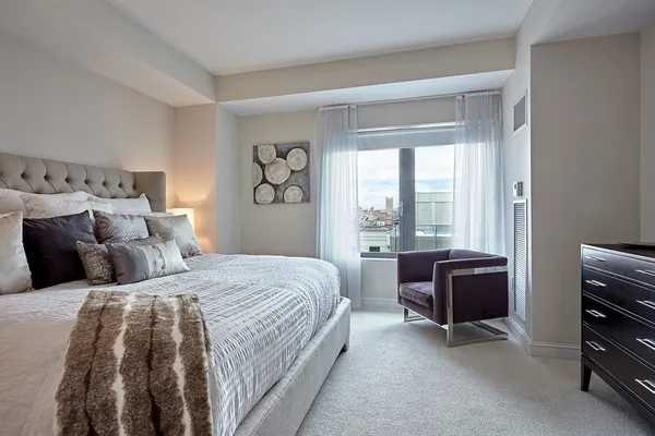 a bedroom with a bed and a desk