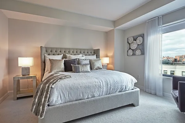 a bedroom with a bed and window