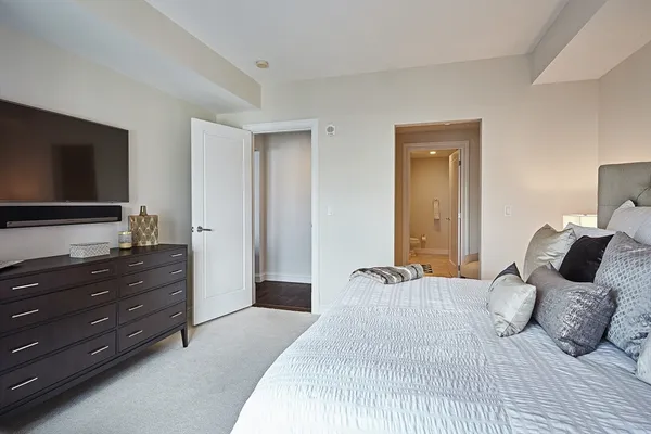 a bedroom with a bed and a flat screen tv