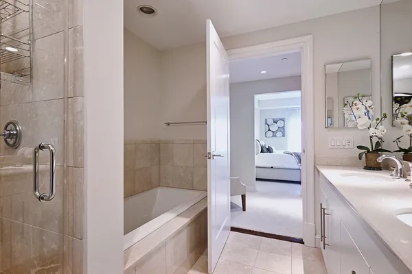 a bathroom with a tub sink and mirror