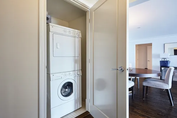 a view of a livingroom with furniture and washing machine