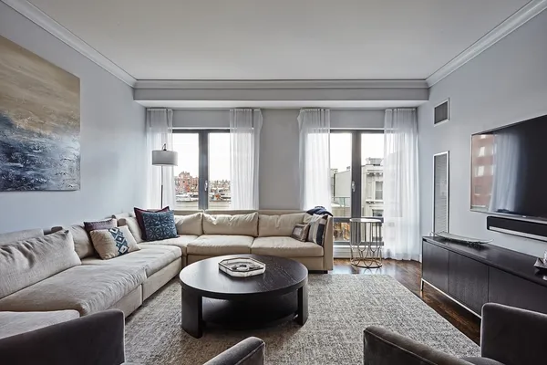a living room with furniture and a large window