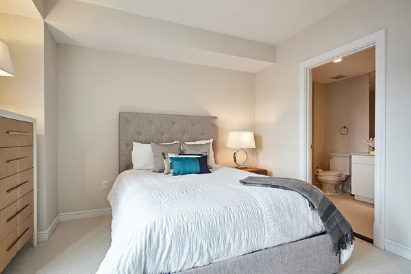 a bedroom with a bed and a night stand